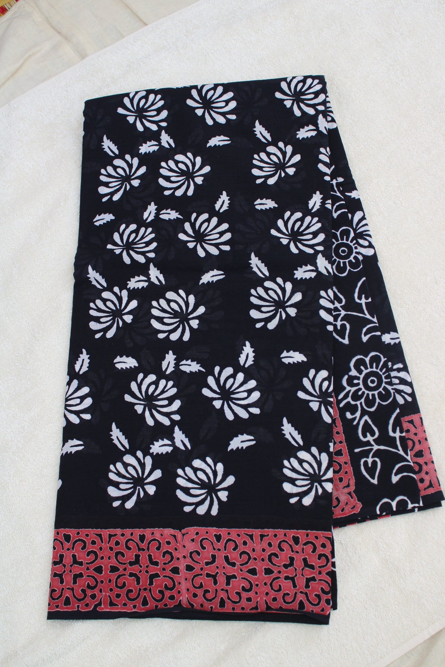 Black with white flower block printed mul cotton saree with Reb border