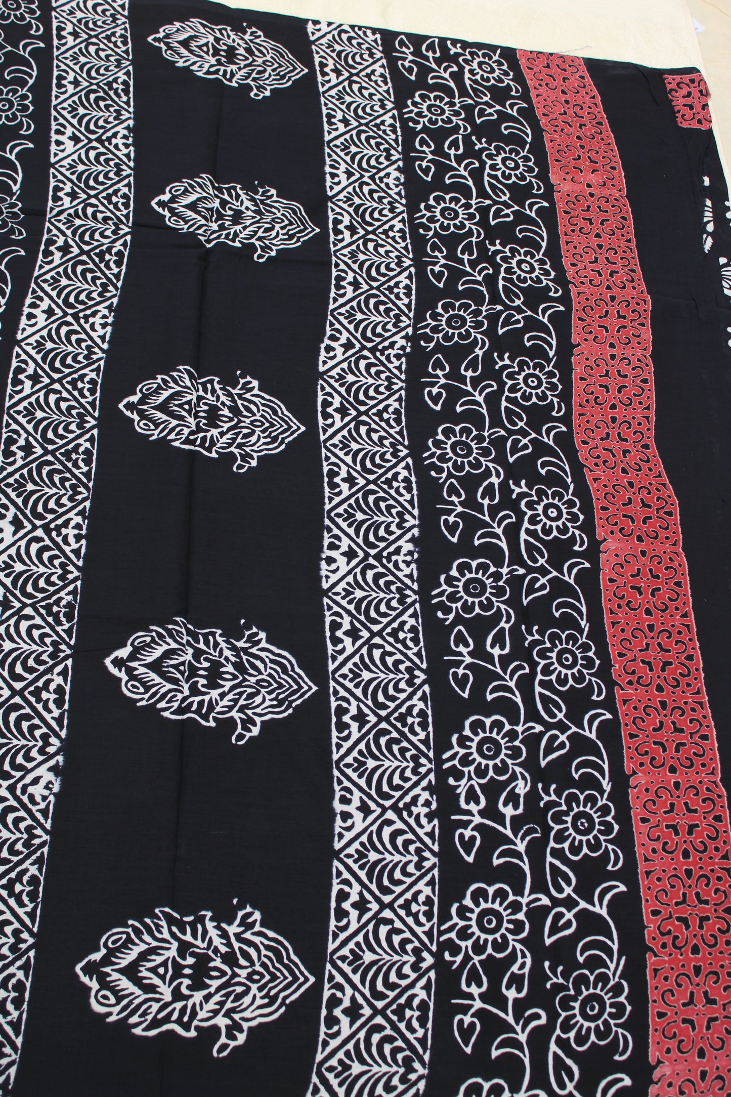 Black with white flower block printed mul cotton saree with Reb border