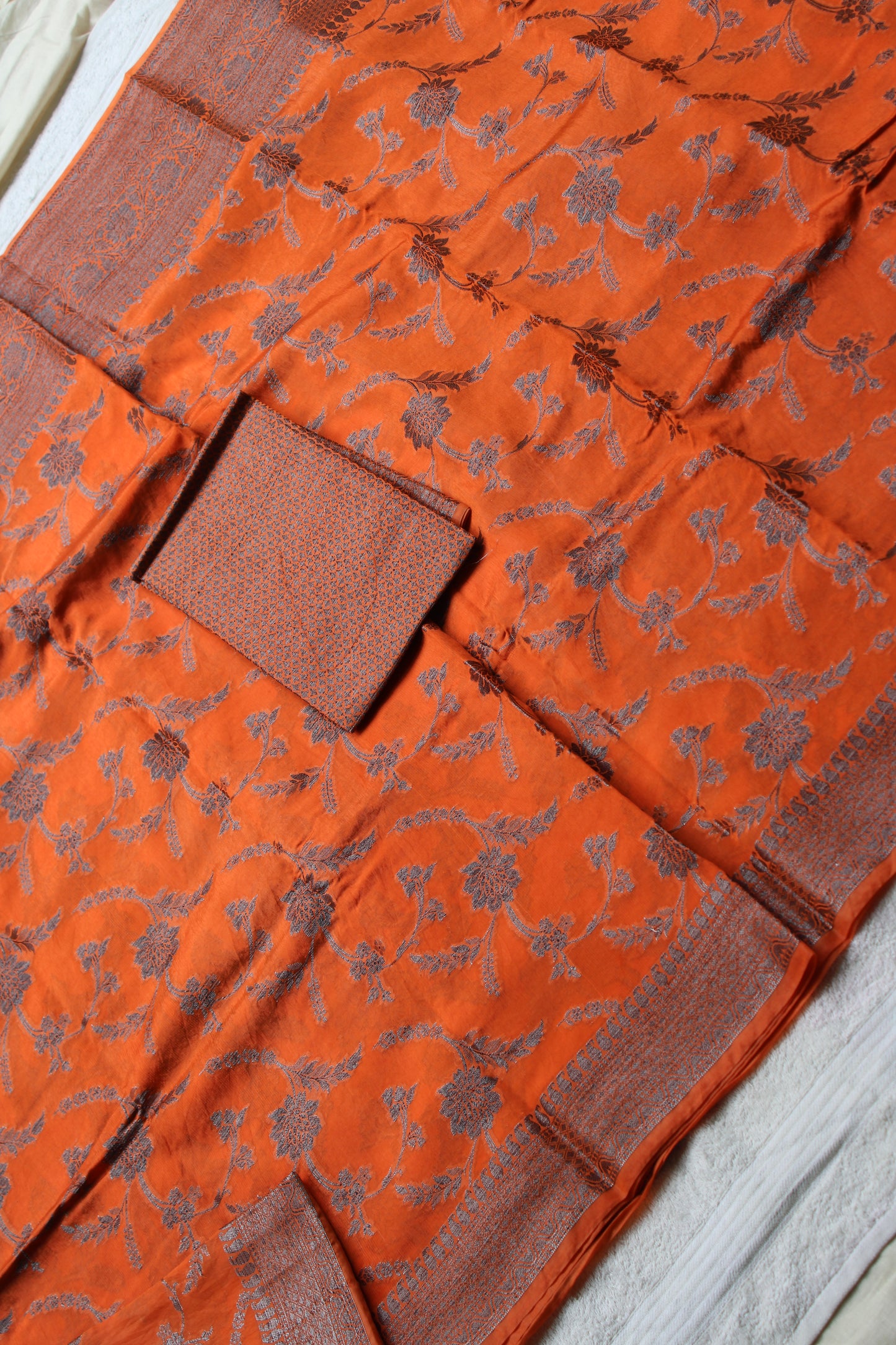 Orange raw mango saree with black zari weaving