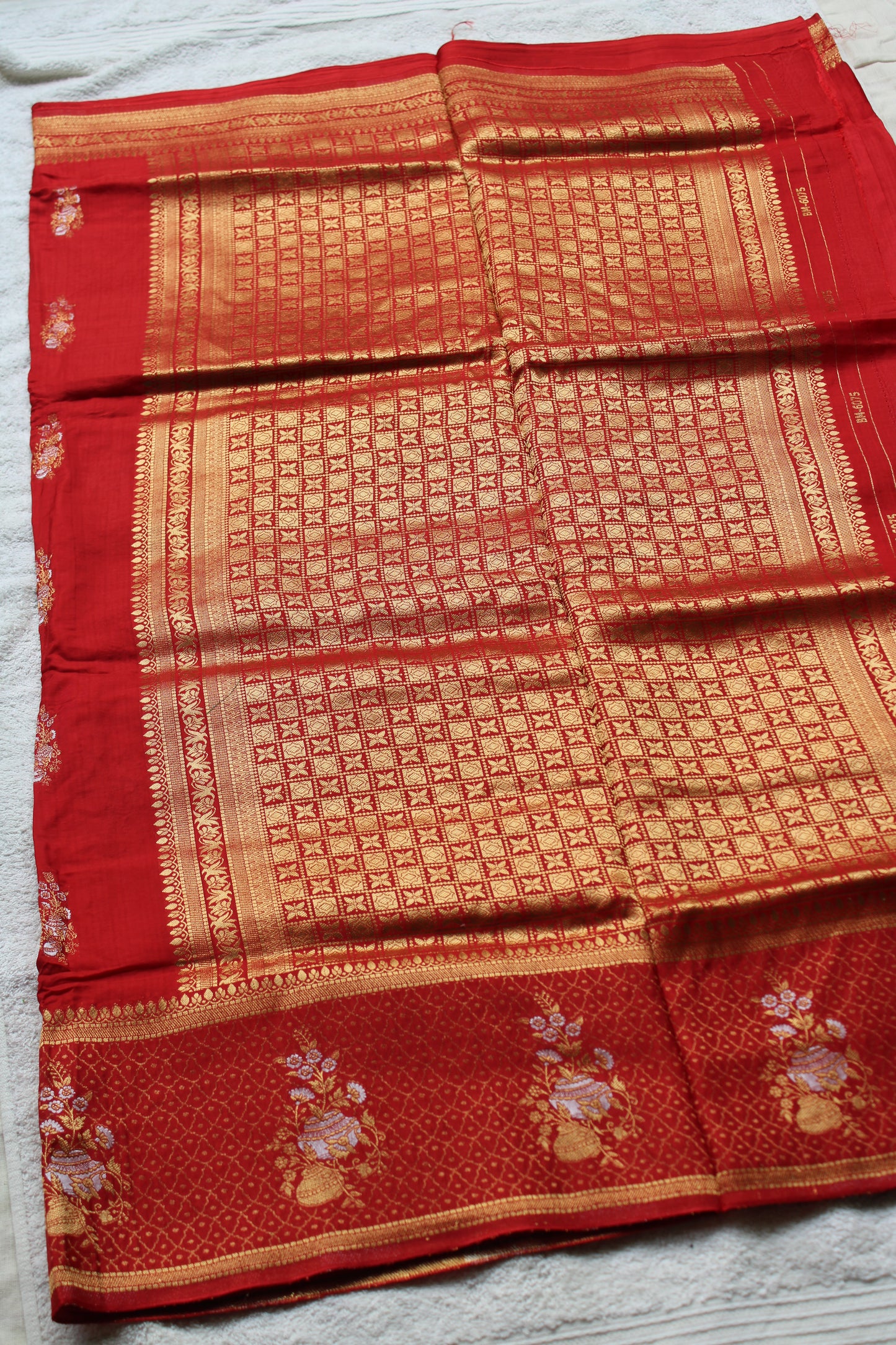 Orange Banarasi Russian crape saree with checked and floral border