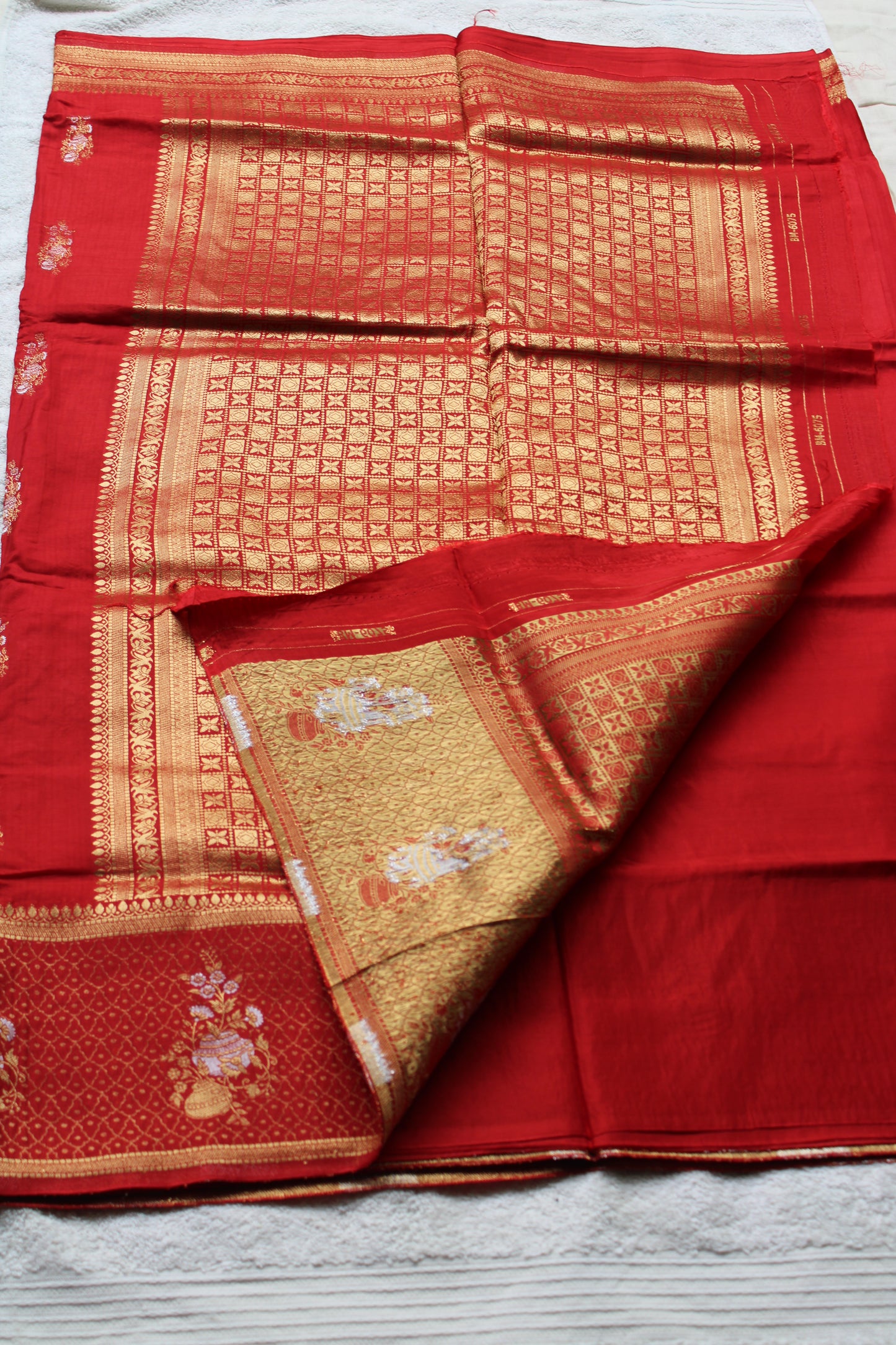 Orange Banarasi Russian crape saree with checked and floral border