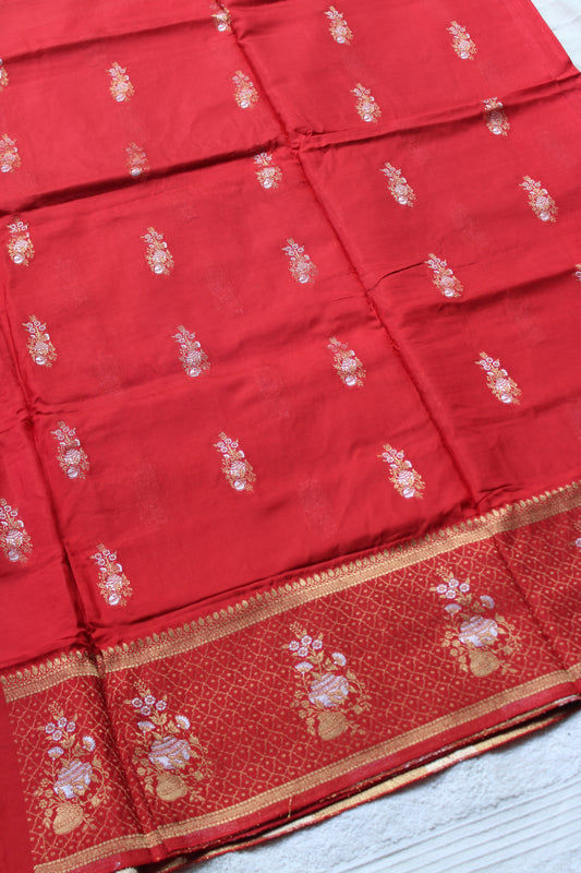 Orange Banarasi Russian crape saree with checked and floral border