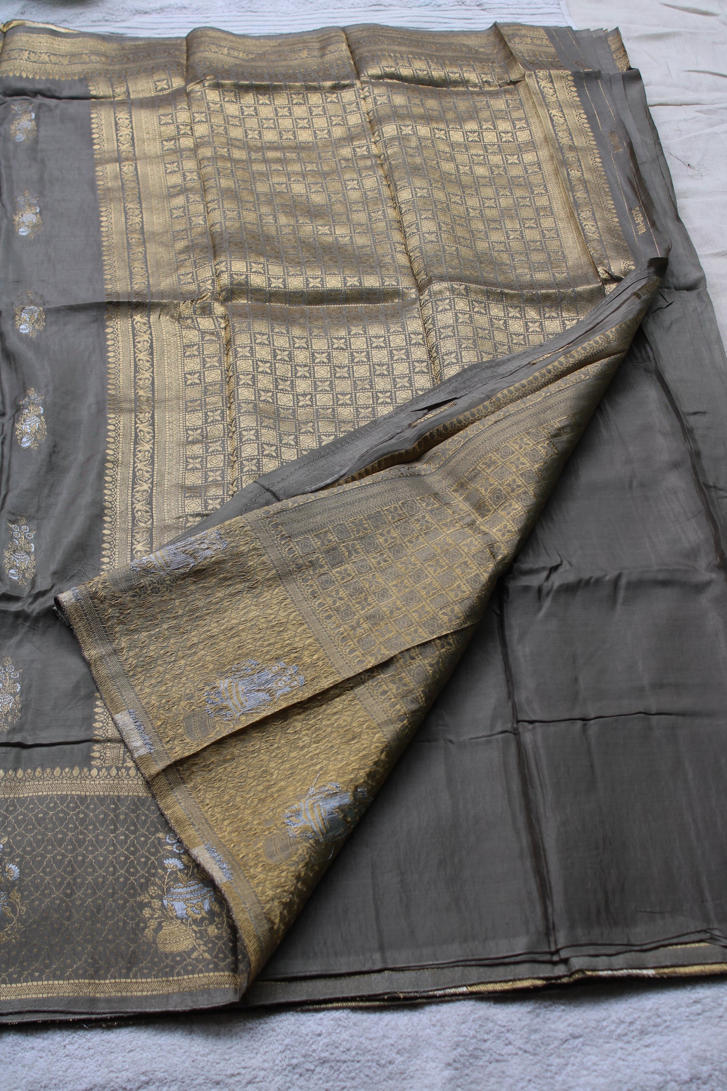 Ash green Banarasi Russian crape saree with checked and floral border