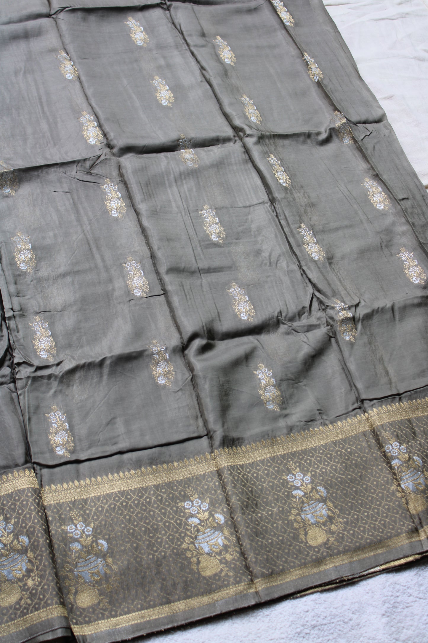 Ash green Banarasi Russian crape saree with checked and floral border