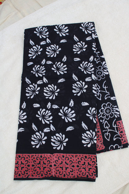 Black with white flower block printed mul cotton saree with Reb border