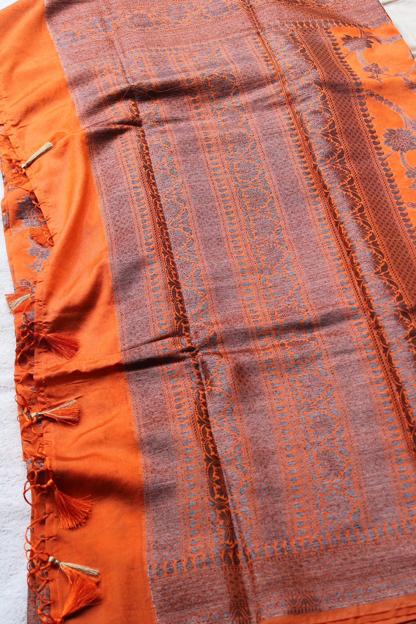Orange raw mango saree with black zari weaving