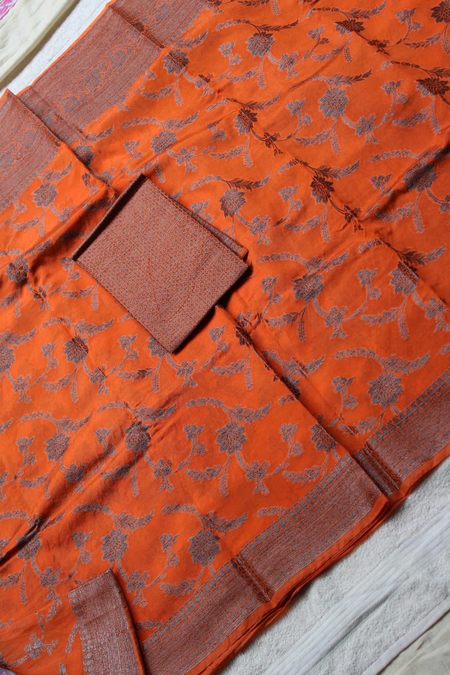 Orange raw mango saree with black zari weaving