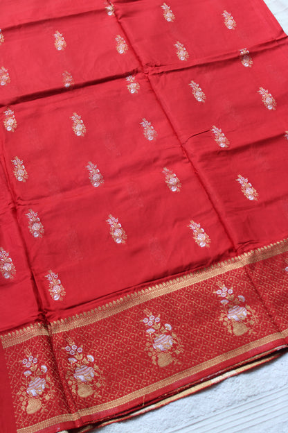 Orange Banarasi Russian crape saree with checked and floral border